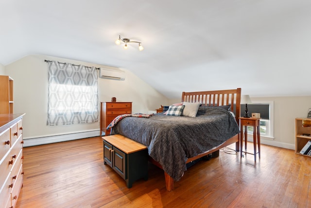 bedroom featuring a baseboard heating unit, an AC wall unit, lofted ceiling, and light wood finished floors