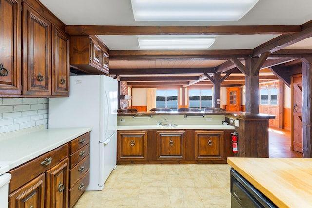 44 Periwinkle Ln, Phippsburg, ME 04562 - kitchen featuring a wealth of natural light, beam ceiling, backsplash, and light countertops