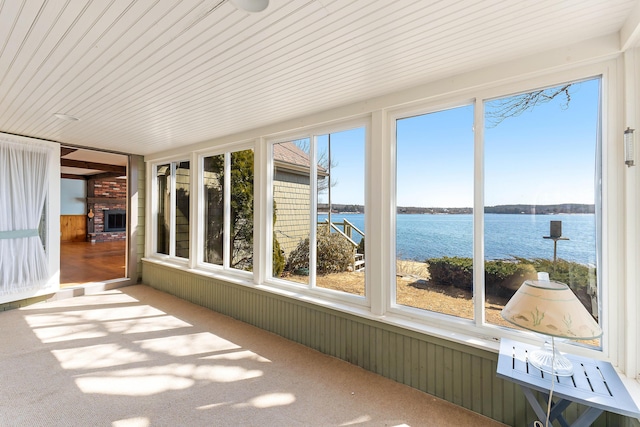44 Periwinkle Ln, Phippsburg, ME 04562 - unfurnished sunroom with wooden walls, plenty of natural light, carpet, and a water view