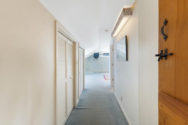 44 Periwinkle Ln, Phippsburg, ME 04562 - corridor with vaulted ceiling, a baseboard heating unit, baseboards, and carpet floors