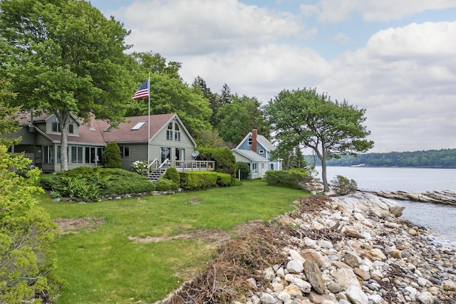 44 Periwinkle Ln, Phippsburg, ME 04562 - view of front of home with a front lawn, concrete driveway, a water view, and a chimney