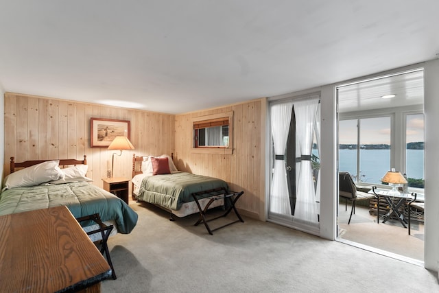 44 Periwinkle Ln, Phippsburg, ME 04562 - carpeted bedroom with access to exterior, wooden walls, and a water view