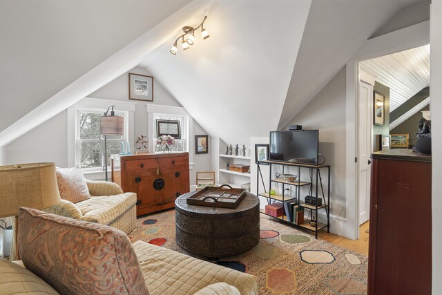 living room featuring lofted ceiling and wood finished floors