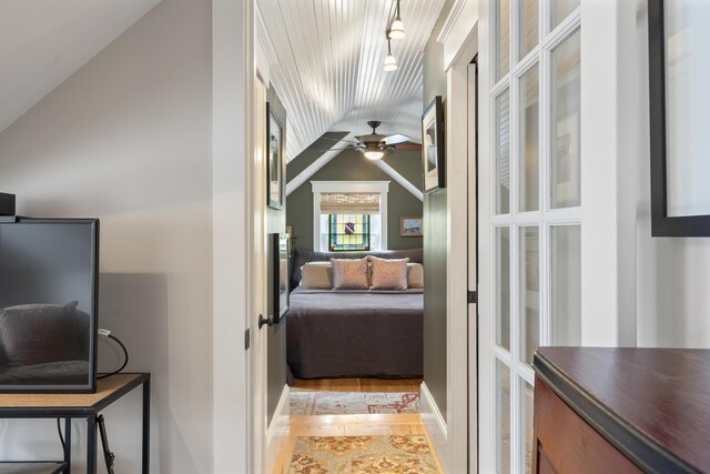 bedroom with lofted ceiling and wood finished floors