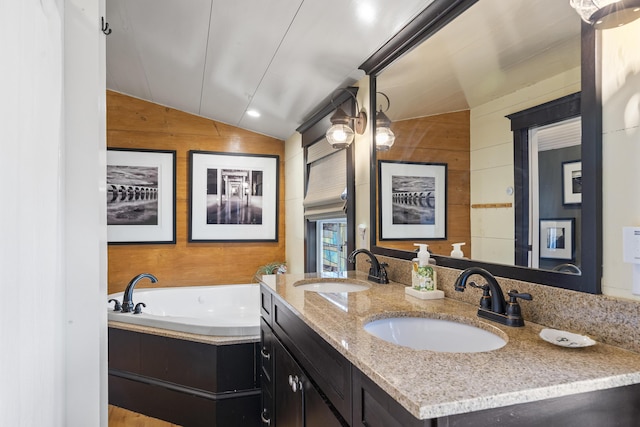 full bathroom featuring double vanity, wooden walls, lofted ceiling, and a sink