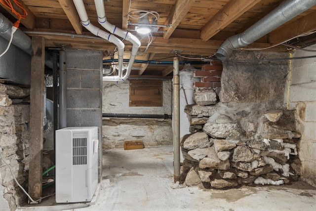 unfinished below grade area featuring heating unit