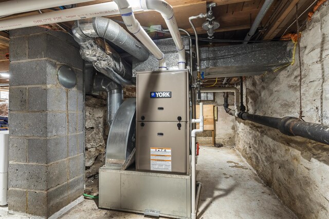 utility room featuring heating unit