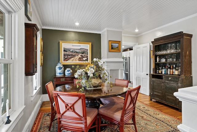 dining area with recessed lighting, wood finished floors, and ornamental molding