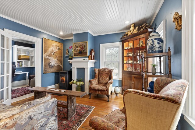 living area featuring hardwood / wood-style floors and ornamental molding