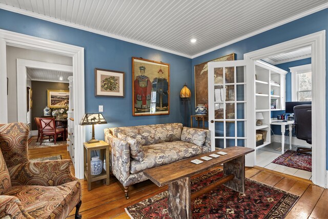 living area with ornamental molding and wood-type flooring