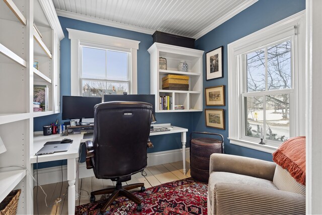 home office with a healthy amount of sunlight and crown molding