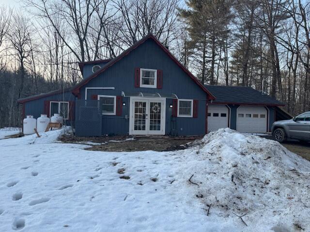 rustic home with french doors and a garage