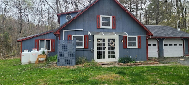 view of front of house featuring a garage, a front yard, and driveway