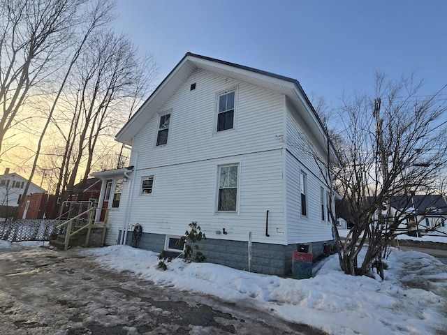 view of snow covered rear of property