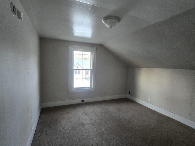 bonus room featuring lofted ceiling, baseboards, and carpet floors