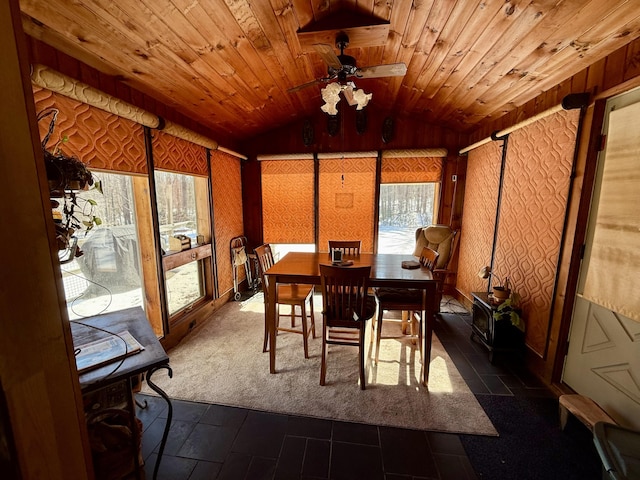 sunroom / solarium featuring wood ceiling, a ceiling fan, and vaulted ceiling