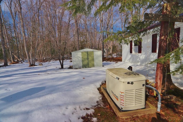 yard layered in snow with an outbuilding and a storage shed