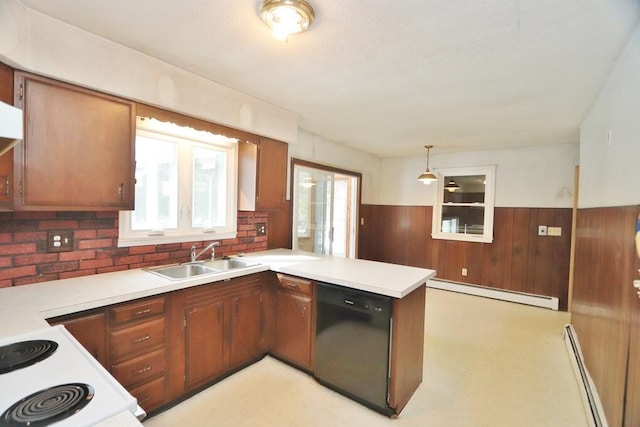 kitchen featuring a sink, black dishwasher, baseboard heating, and a peninsula