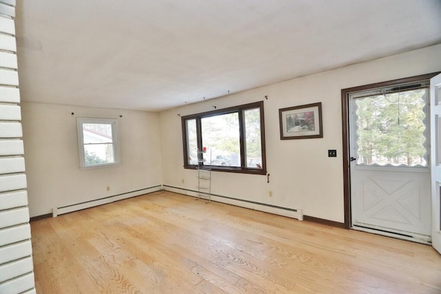 interior space with light wood-style flooring and a baseboard heating unit