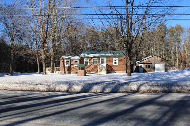 view of front of house with an outbuilding and a detached garage