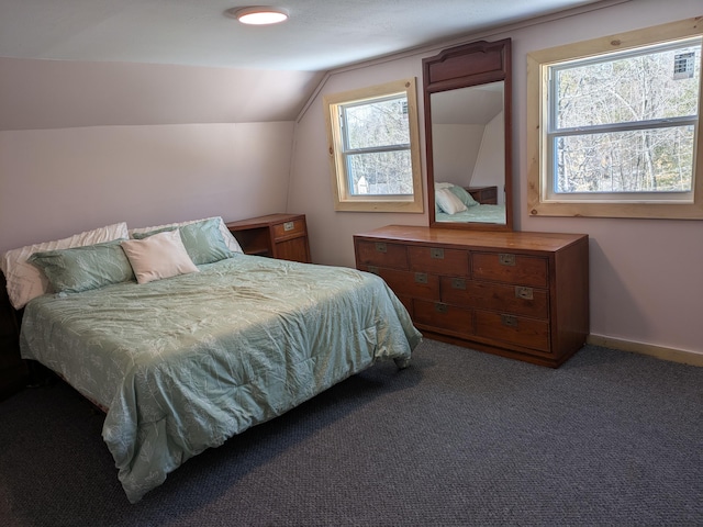 carpeted bedroom featuring baseboards and vaulted ceiling