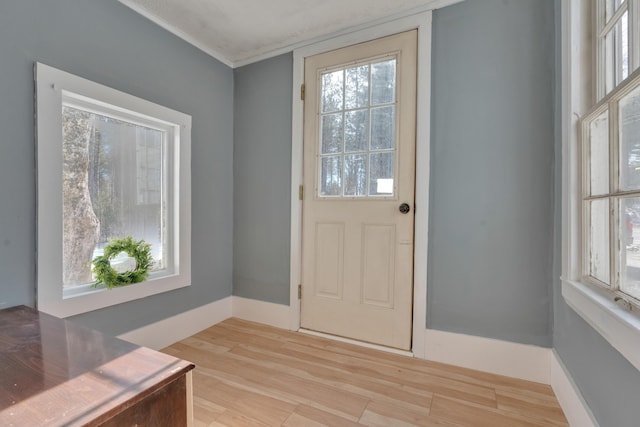 entryway with baseboards and light wood-type flooring