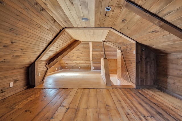 bonus room with wooden walls, wood ceiling, and hardwood / wood-style floors