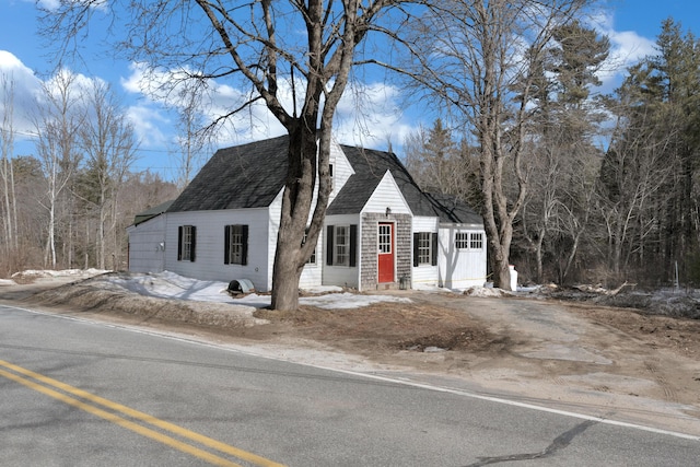 view of front of property with entry steps and a shingled roof