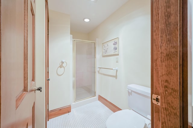 full bath with a shower stall, toilet, and baseboards