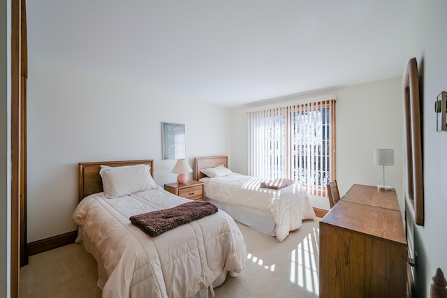 bedroom featuring baseboards and light colored carpet