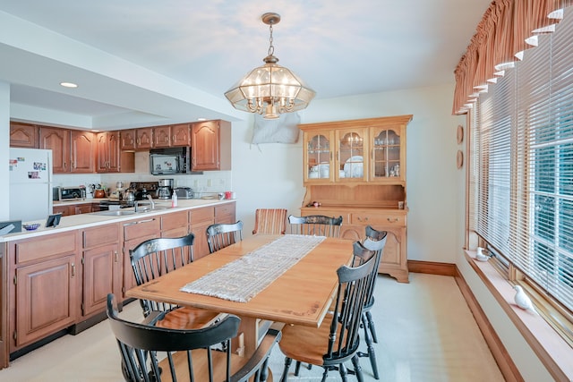 dining room with an inviting chandelier and baseboards