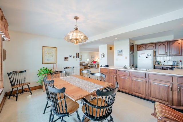 dining room with an inviting chandelier and baseboards