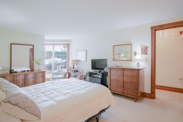 bedroom with baseboards and light carpet