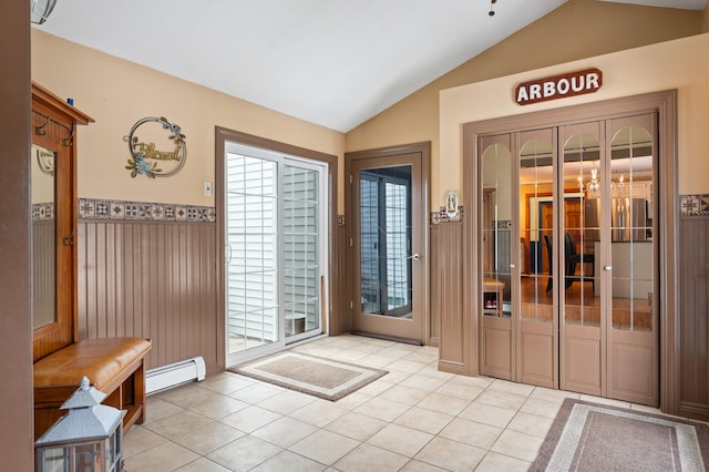 doorway to outside featuring a healthy amount of sunlight, lofted ceiling, and a baseboard radiator