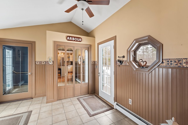 entrance foyer with light tile patterned floors, a wainscoted wall, lofted ceiling, and a baseboard radiator