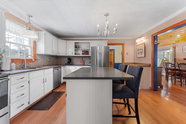 kitchen featuring a sink, open shelves, dark countertops, appliances with stainless steel finishes, and white cabinets