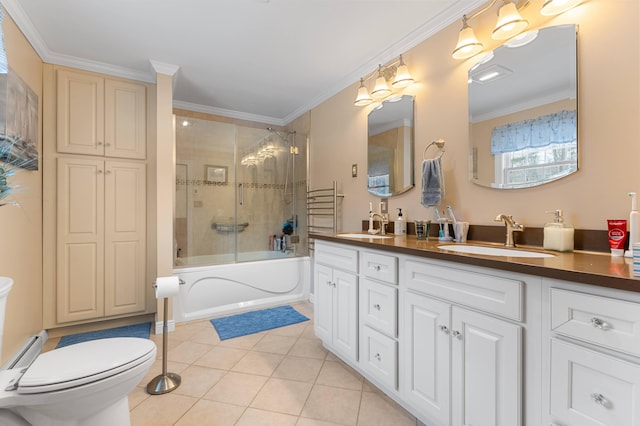 bathroom with tile patterned flooring, toilet, vanity, and ornamental molding