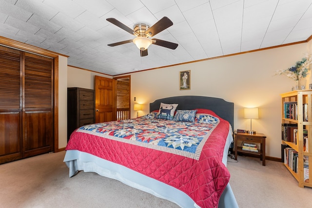 carpeted bedroom featuring baseboards, a ceiling fan, and crown molding