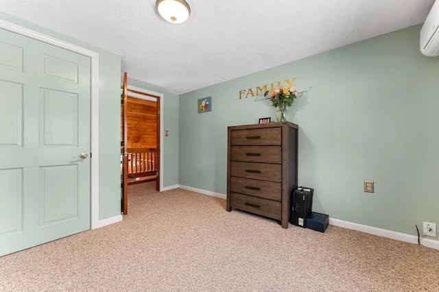 bedroom with a textured ceiling, baseboards, and light carpet