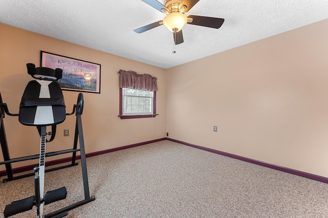 exercise area featuring baseboards, a textured ceiling, carpet, and a ceiling fan