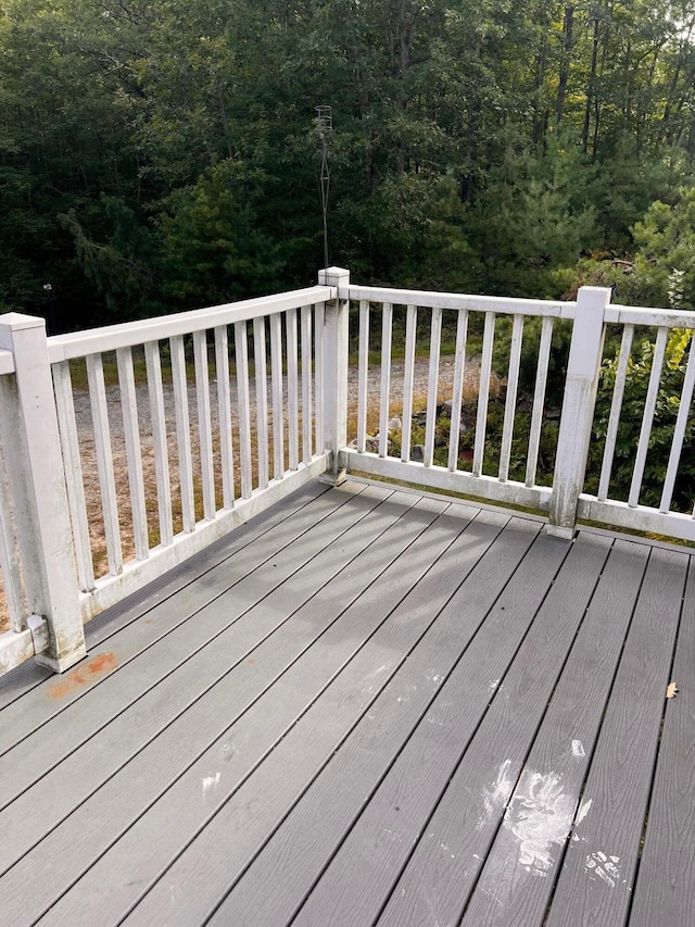 wooden deck with a forest view