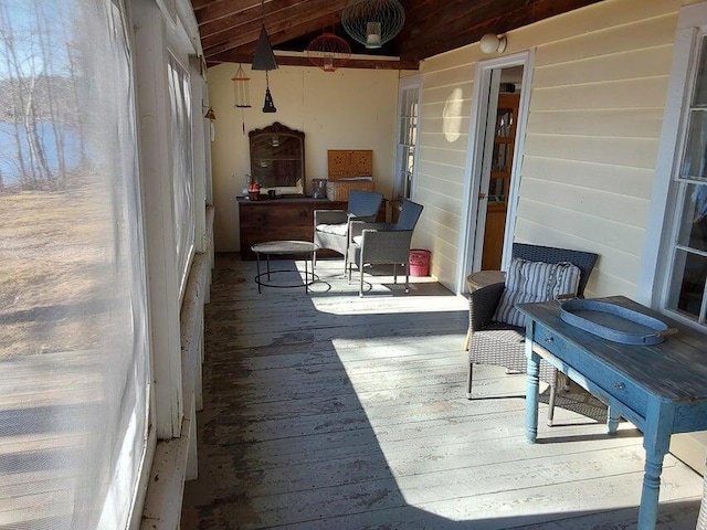 sunroom / solarium featuring wooden ceiling and vaulted ceiling