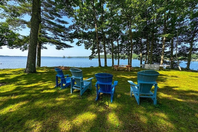 view of yard with an outdoor fire pit and a water view