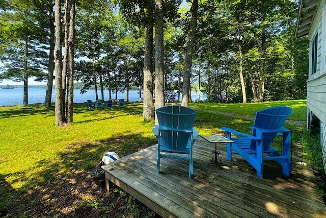 wooden deck with a lawn and a water view