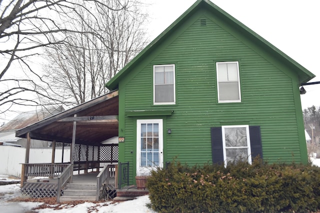 view of snow covered rear of property