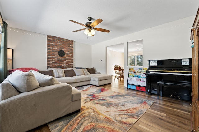 living room with wood finished floors and ceiling fan