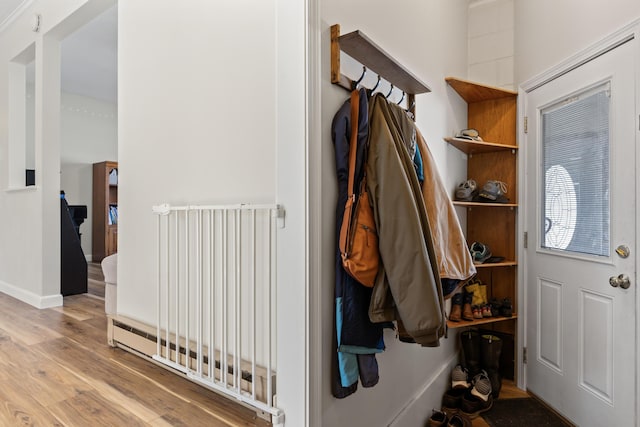 mudroom featuring wood finished floors and baseboards