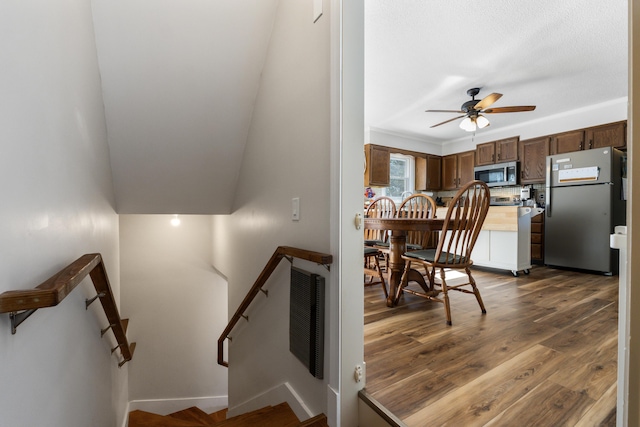 staircase with visible vents, baseboards, wood finished floors, and a ceiling fan