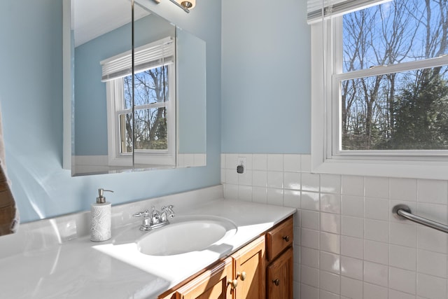 bathroom featuring tile walls and vanity