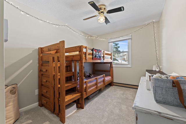 bedroom with a baseboard radiator, light carpet, a textured ceiling, and a ceiling fan